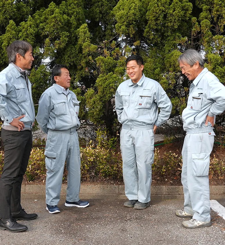 休憩中や作業の合間に、輪になって談笑する4人の社員たち